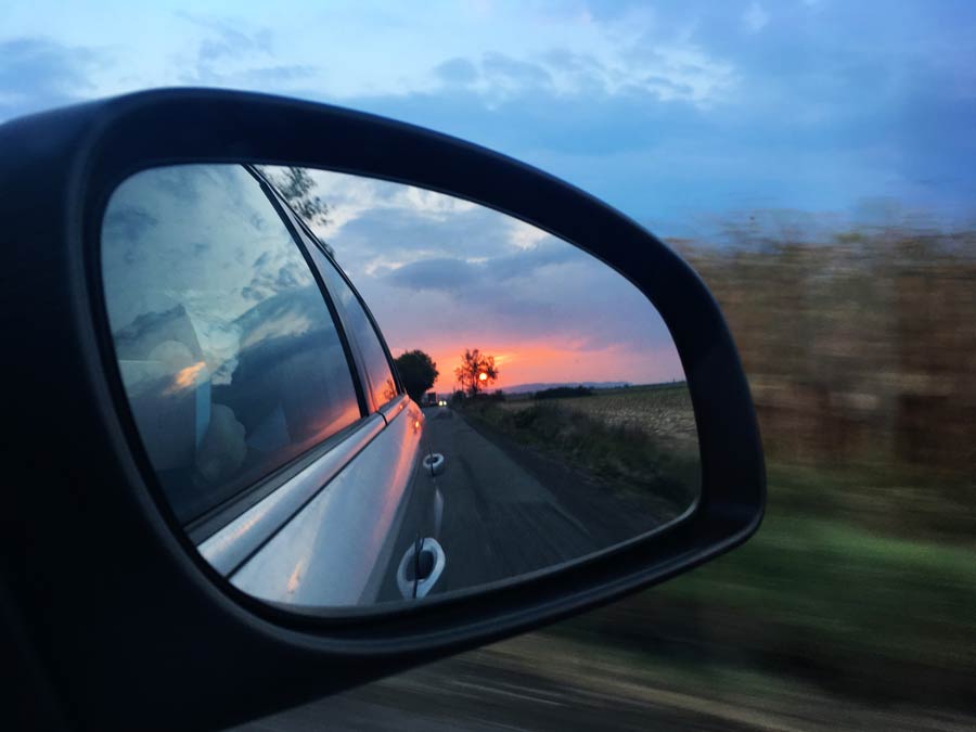 sunset in car side view mirror